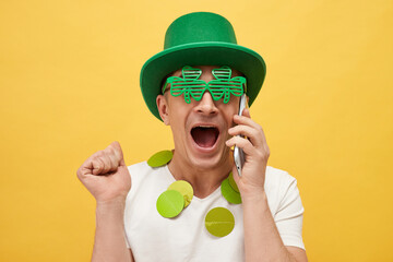 Greetings for Irish celebrations. St. Patrick's Day mythology. Amazed Caucasian man wearing green...
