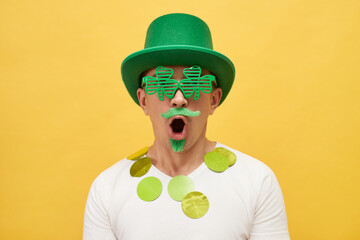 Irish culture celebration. Celebrating Irish religion. Shocked Caucasian man wearing green...