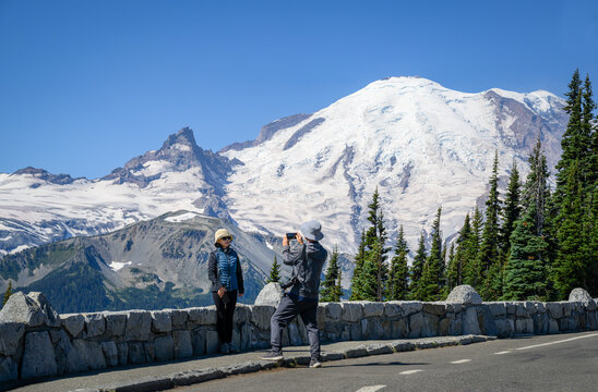 Tourists taking photos using smartphone at Sunrise Trail. Mount Rainier National Park. Washington State.