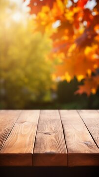 An empty brown wooden countertop on a blurred autumn background on a sunny day. Vertical photo for Product presentation, Advertising, Copy space.