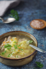 A bowl with chicken soup with pasta