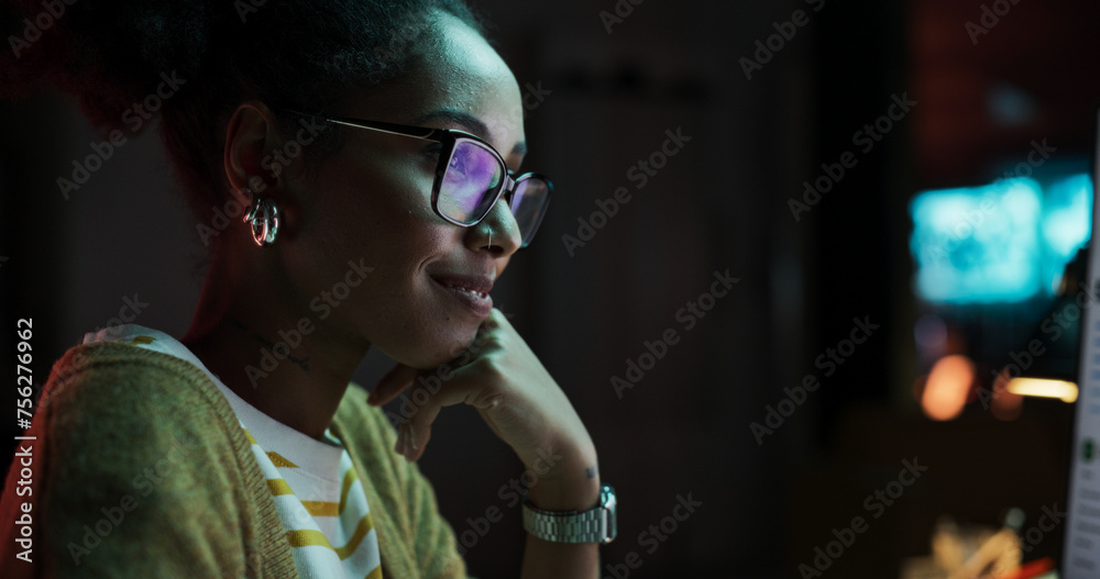 Poster Portrait of Black Female Video Game Designer Creating Metaverse and Design Video Game Character in Creative Office at Night. Focused Woman Working on a New 3D Level on Her Desktop Computer