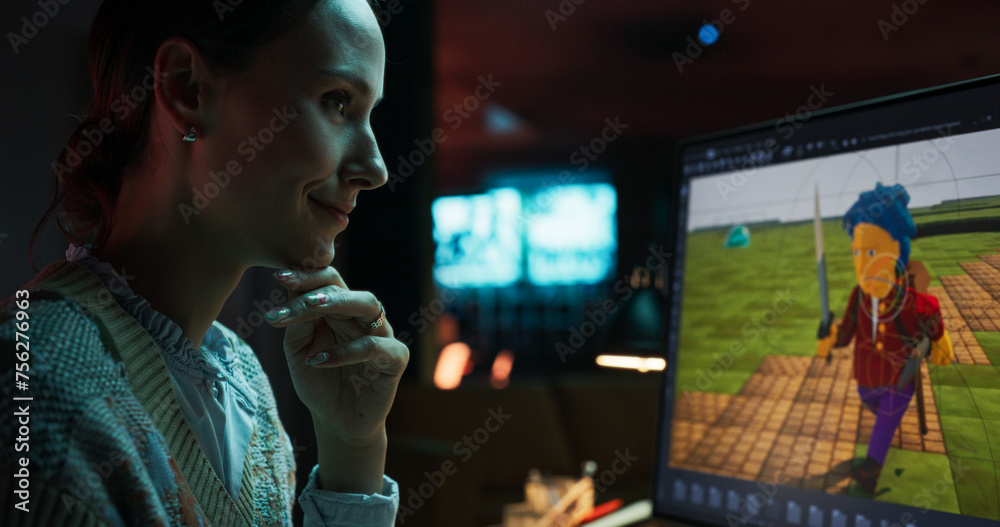 Fototapete Portrait of Female Video Game Designer Working on a New 3D Level on Her Desktop Computer. Focused Woman Creating Metaverse and Design Video Game Character in Creative Office at Night
