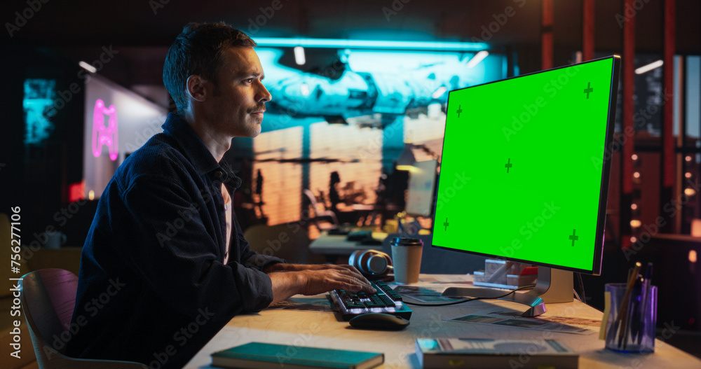 Poster Portrait of Male Working in Creative Agency Office, Checking Data and Sending E-Mails. Successful Specialist Using Desktop Computer with Green Screen Mock Up Display During Night