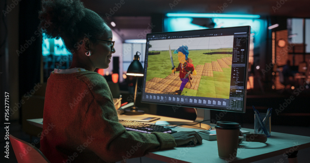 Poster Portrait of Black Female Video Game Designer Creating Metaverse and Design Video Game Character in Creative Office at Night. Focused Woman Working on a New 3D Level on Her Desktop Computer