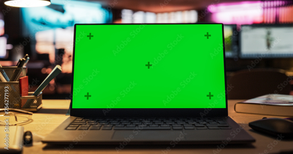 Aufkleber Laptop Computer with Green Screen Standing on a Wooden Desk with Height Adjustable Function. Chroma Key Display in Empty Decorated Creative Office for Game Development Startup