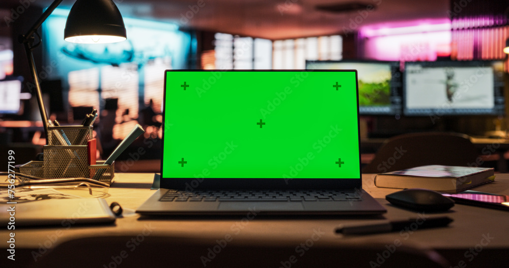 Leinwandbilder Laptop Computer Standing on a Wooden Desk with a Green Screen Chromakey Mock Up Display. Creative Office Working Station for Game Developer and Graphic Designer in Creative Agency