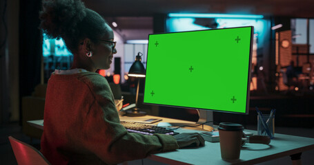 Over the Shoulder: African Female Specialist Working on Computer with Chroma Key Display at...