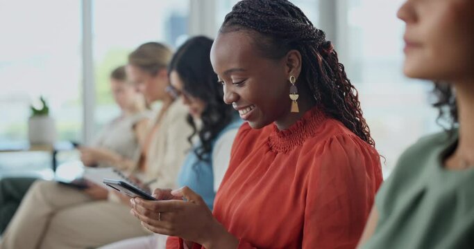 Happy, black woman and typing with phone in row for communication, networking or chatting in waiting room. African female person, intern or employee with smile on mobile smartphone for online texting