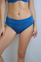 Women's blue turquoise bikini panties on an unrecognizable model.