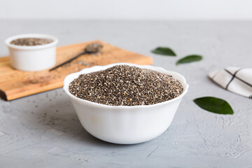 Chia seeds in bowl and spoon on colored background. Healthy Salvia hispanica in small bowl. Healthy superfood