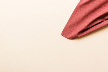 top view with red empty kitchen napkin isolated on table background. Folded cloth for mockup with copy space, Flat lay. Minimal style