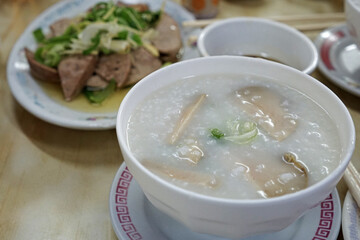 Close up bowl of Rice Congee porridge served with Scalding Liver pork