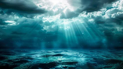 Deurstickers Blue and turquoise ocean waters with cloudy skies furrowed by the sun's rays © Petruta