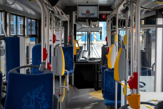 Inside view of passenger bus cabin with seats. Onboard autobus coach in service for MPK Krak&oacute;w Public Transport in Cracow. Empty interior of city mass transit bus on March 2, 2024 in Krakow, Poland.
