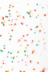 Colorful confectionery sprinkles on white background. Decoration for cake and bakery.