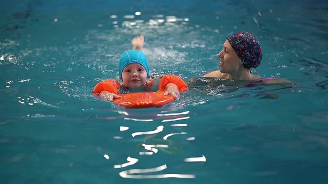 mother raising daughter.family in the pool. High quality 4k footage