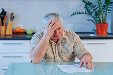 Emotional Turmoil Distressed Mature Man Reacts to Dismissal Letter at Home - obrazy, fototapety, plakaty