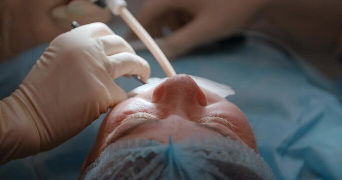 Patient is going through dental surgery in dental clinic