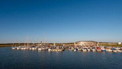 Fototapeta na wymiar Boats in Esbjerg Strand marina, Esbjerg city, Jutland, Denmark, on North Sea coast