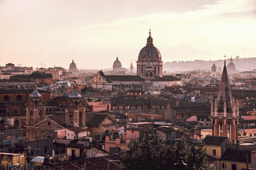 Fototapeta na wymiar Rome panoramic view. A glowing sunset bathes the historic skyline of Rome in warm light, showcasing the city's iconic architecture and domed cathedrals. Rome, Italy