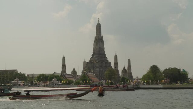 Famous Buddhist temple Wat Arun Ratchawararam view of main prang of across Chao Phraya River in day time.