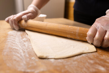 Preparation and rolling out puff pastry. Preparation of puff pastry dishes.