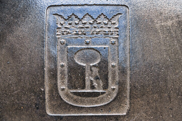 Coat of arms or symbol, engraving on a street tile, Madrid, Spain 