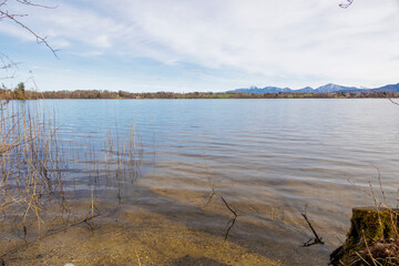 View from the shore of Lake Staffelsee towards Seehausen and the Kochel mountains in Bavaria