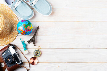 Travel planning simple background of compass, film camera, straw hat, moccasins, globe and...
