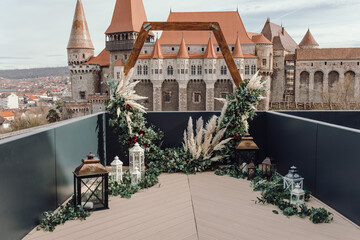 Wedding ceremony at old castle. Wedding decor near ancient Castle. Corvin Castle, Romania