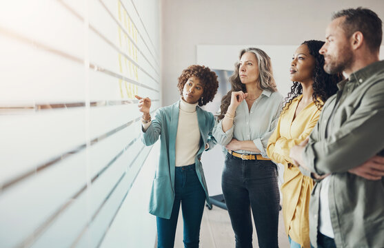 Group of diverse businesspeople talking during an office brainstorming session