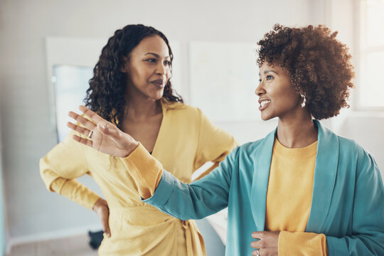 Smiling african american businesswomen talking together in an office boardroom