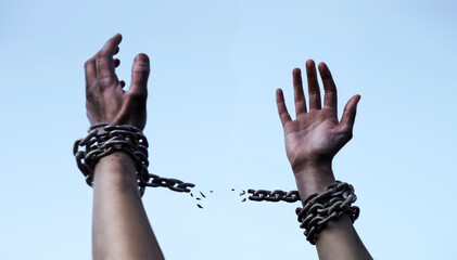 Praying man with shackled hands