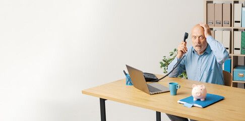 Shocked businessman receiving financial advice on the telephone