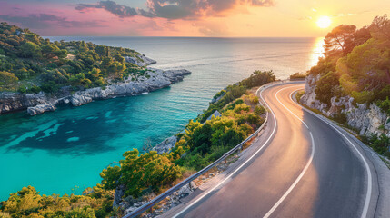 Scenic coastal road winding along turquoise water at sunset - obrazy, fototapety, plakaty