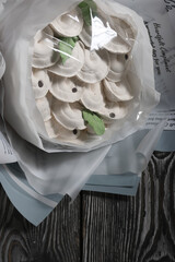 Bouquet of marshmallow dumplings. Marshmallow dumplings. Homemade marshmallows. on a black wooden background. Place for text.