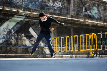 Full length shot of attractive male hip hop dancer practicing dance on the street