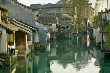 Traditional Chinese houses by a green river in Wuzhen, Zhejiang, China