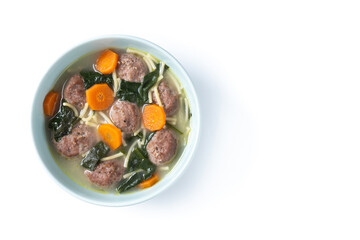 Italian Wedding Soup with meatballs and spinach isolated on white background. Top view. Copy space