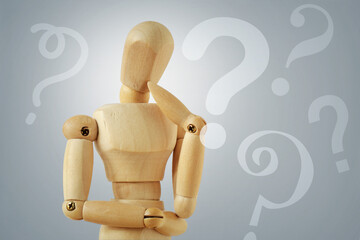 Wooden mannequin in thinking pose with quesion marks - Concept of question thinking and doubts - 756342169