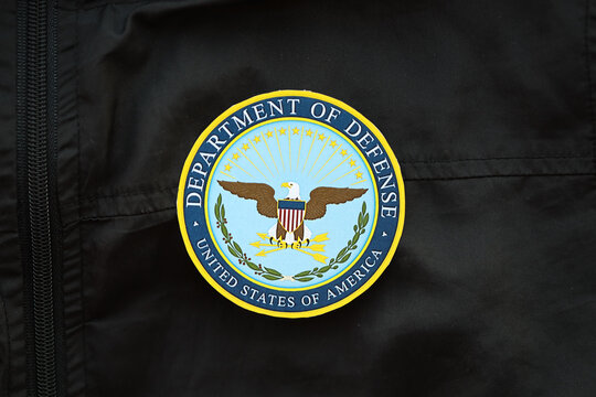 KYIV, UKRAINE - MARCH 9, 2024 US Department of Defense seal on black jacket uniform close up