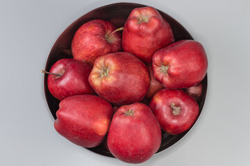Fototapeta na wymiar Red apples in the stainless steel bowl, top view