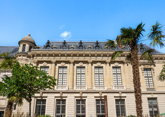 Fototapeta na wymiar Building in the courtyard of Mazarin Library (Bibliothèque Mazarine), in the Palace of the Institute of France, with palm trees, 6th arrondissement, Paris city center