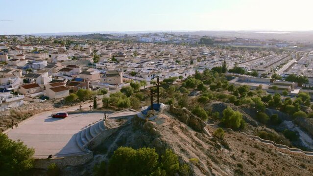 Aerial view of Rojales townscape with Monte Calvario and three crosses against blue sky view. Rojales, town, Spain
