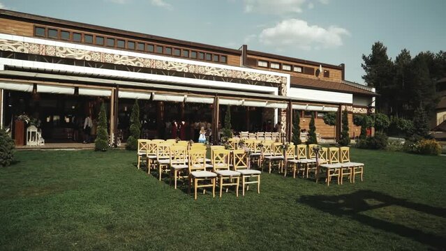 Chairs lined up for wedding ceremony in front of a building