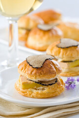 Obraz na płótnie Canvas Puff pastry buns stuffed with foie gras and black truffle...