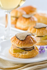 Puff pastry buns stuffed with foie gras and black truffle...