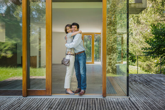 gl&uuml;ckliches Paar umarmt sich in neu gekaufter oder gemieterer Immobilie, Bayern, Deutschland