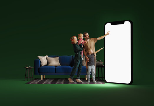 Family interacting with huge 3D model of smartphone in living room against green background. Online shopping, entertainment apps, sales. Mockup for ad, text, design, logo. Modern technologies - Powered by Adobe